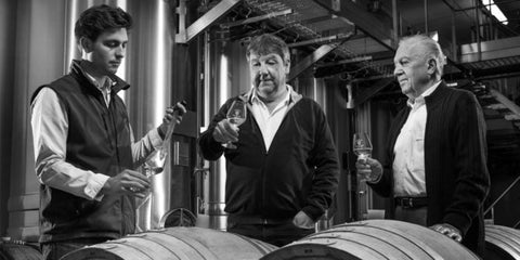 Winemakers tasting from barrels at Champagne Salmon