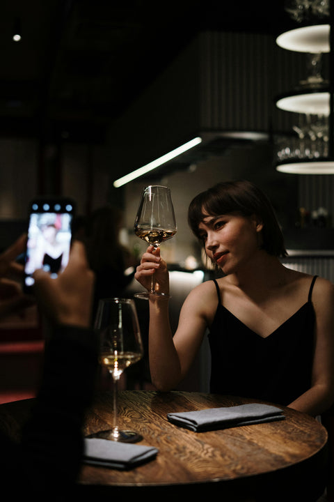 Woman posing for photo with wine glass