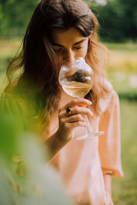 Woman tasting white wine
