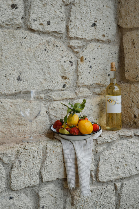 Wine bottle, glass, and fruit bowl