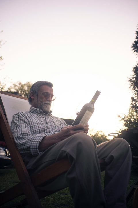 Man reading wine label