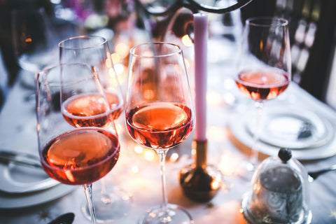 Rose wine glasses on dinner table