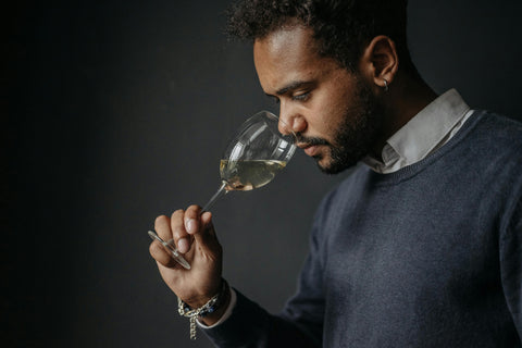 Man smelling wine